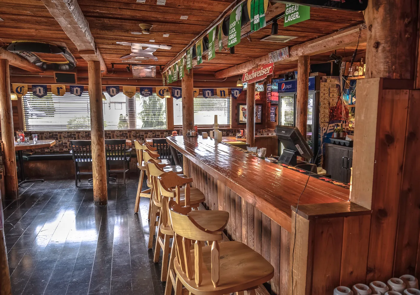 The log-beamed bar at Bob’s Burgers & Brew with wooden stools